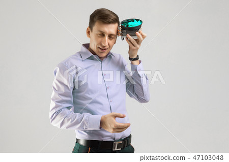 young man leaned against the head of the cooler from computer isolated on a light background 47103048