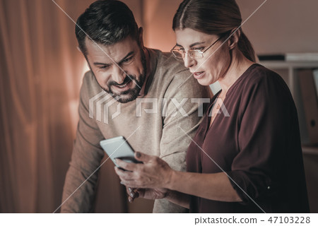 Reflective two colleagues receiving message Reflective two colleagues receiving message 47103228