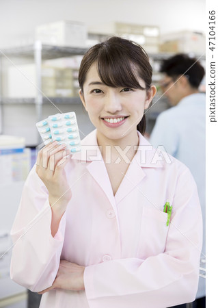 Dispensing pharmacist medical image Pharmacist woman portrait with pill 47104166