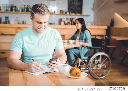 Busy sales manager making notes in a notebook 47104729