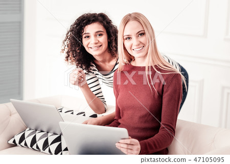 Delighted young women smiling to you 47105095