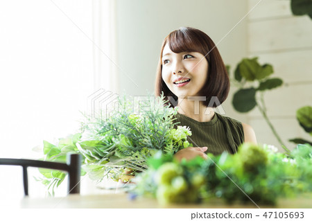 Woman flower bouquet botanical flower arrangement 47105693