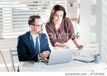 Serious two colleagues exchanging advices Serious two colleagues exchanging advices 47105868