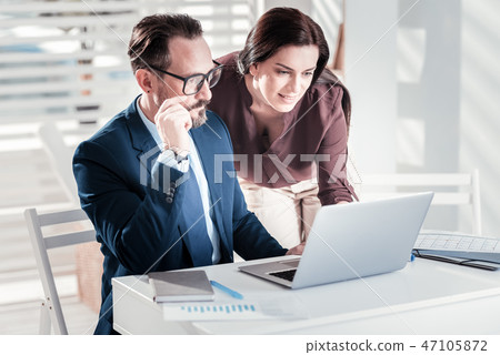 Concentrated two colleagues consulting with each other Concentrated two colleagues consulting with each other 47105872