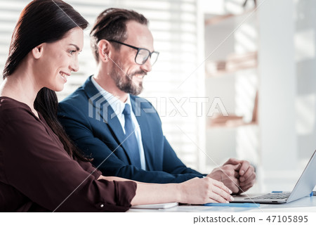 Joyful two colleagues focusing on work 47105895