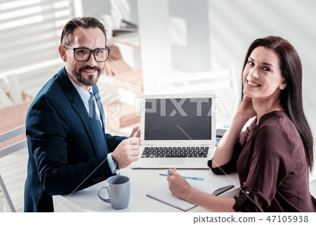 Happy two colleagues working on report 47105938