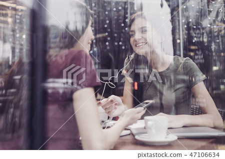 Joyful girl communicating with her friend Joyful girl communicating with her friend 47106634