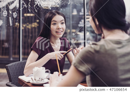 Cheerful brunette having friendly conversation 47106654