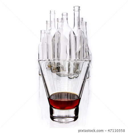 glasses and bottles for brandy and wine in the background 47110358