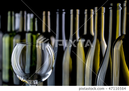 glasses and bottles for brandy and wine in the background 47110384