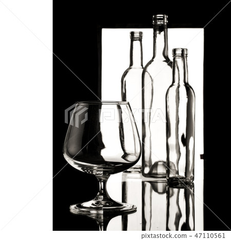 glasses and bottles for brandy and wine in the background 47110561
