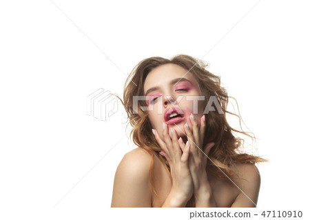 Nice young woman with long wavy silky hair, natural make up looking at camera 47110910