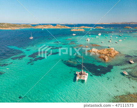 Drone aerial view of catamaran sailing boat in Maddalena Archipelago, Sardinia, Italy. 47111573