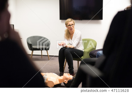 Instructor teaching first aid cardiopulmonary resuscitation course and use of automated external 47111628