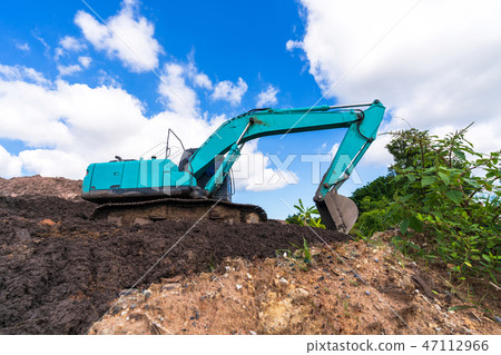 Excavator on construction site under blue sky Excavator on construction site under blue sky 47112966