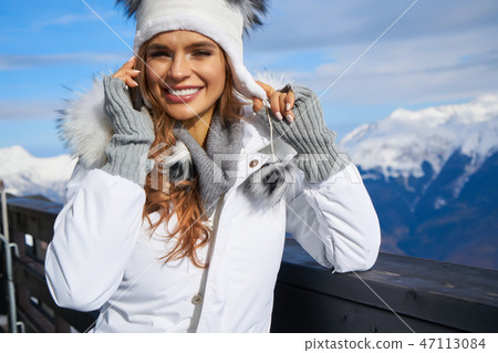 Woman Skier Standing at Snow Looking at Camera. Winter Montain b Woman Skier Standing at Snow Looking at Camera. Winter Montain b 47113084