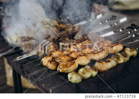 cooking meat potatoes skewers barbecue smoke 47113739