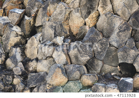 Textured basalt background hexagonal stone pillars in a section. natural volcanic formations 47113928