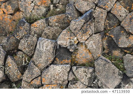 Textured basalt background hexagonal stone pillars in a section. natural volcanic formations 47113930