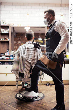 Hipster man client visiting haidresser and hairstylist in barber shop. 47115307