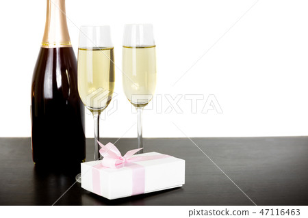 Bottle champagne and two glasses with gift box isolated in white background. Bottle champagne and two glasses with gift box isolated in white background. 47116463