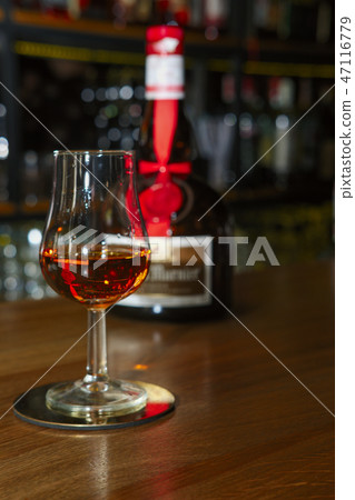 Glass and bottle of liqueur Grand Marnier Glass and bottle of liqueur Grand Marnier 47116779