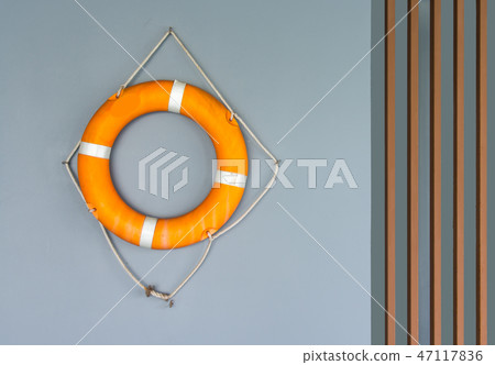 Life buoy loop hanging on concrete wall. Life buoy loop hanging on concrete wall. 47117836