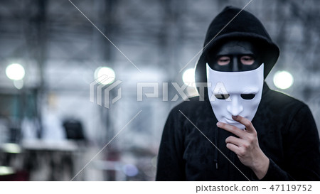 Mystery hoodie man holding white mask Mystery hoodie man holding white mask 47119752