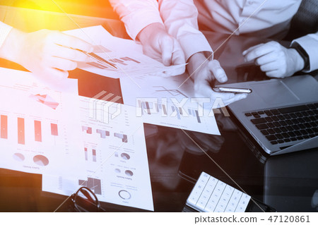 Desk in the office with charts, a laptop and men's hands 47120861