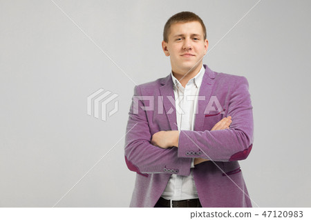 young man in a jacket folded arms isolated on light background young man in a jacket folded arms isolated on light background 47120983