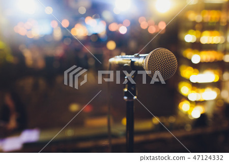 Close up microphone on stage in concert hall restaurant or conference room blurred background. Close up microphone on stage in concert hall restaurant or conference room blurred background. 47124332