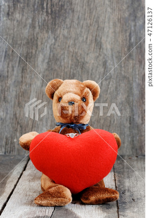 Toy bear doll and the jewelry ring with red heart. Toy bear doll and the jewelry ring with red heart. 47126137