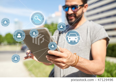 man using car sharing app on tablet pc in city man using car sharing app on tablet pc in city 47129496