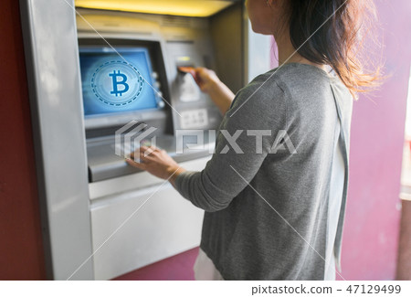 close up of woman inserting card to atm machine close up of woman inserting card to atm machine 47129499