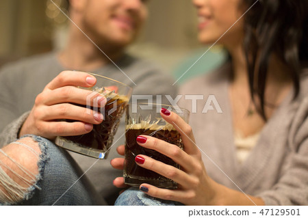 close up of happy couple drinking coffee at home close up of happy couple drinking coffee at home 47129501