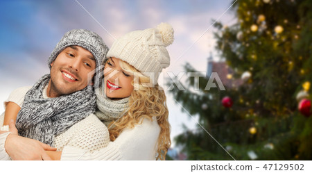 happy couple hugging over christmas tree happy couple hugging over christmas tree 47129502