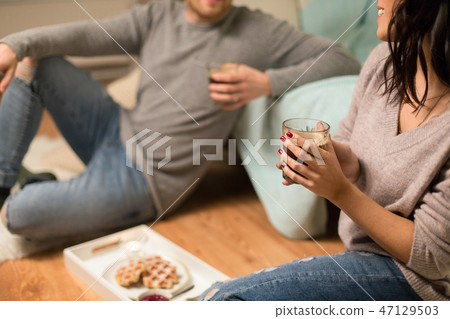 close up of couple drinking coffee at home 47129503