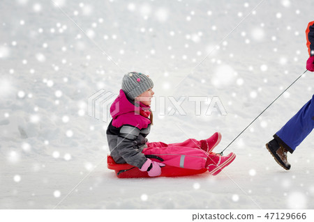 girls with sled having fun outdoors in winter 47129666