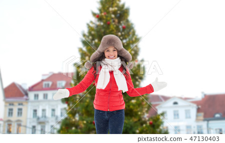 happy woman over christmas tree in tallinn happy woman over christmas tree in tallinn 47130403