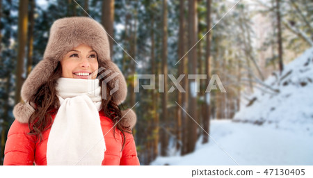 happy woman in winter fur hat outdoors happy woman in winter fur hat outdoors 47130405