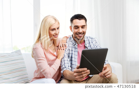 happy couple with tablet computer at home happy couple with tablet computer at home 47130518