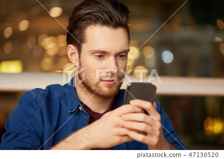 close up of man with smartphone at restaurant close up of man with smartphone at restaurant 47130520