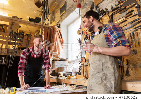 carpenters with ruler and coffee at workshop 47130522