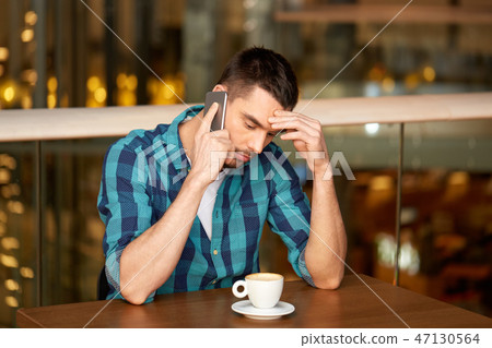 man with coffee calling smartphone at restaurant man with coffee calling smartphone at restaurant 47130564