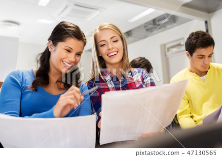 happy student girls with tests at lecture hall happy student girls with tests at lecture hall 47130565