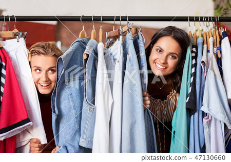 women having fun at vintage clothing store hanger 47130660