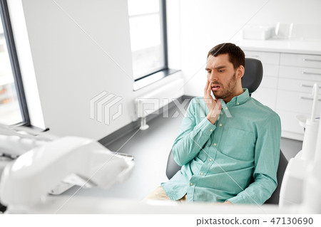 patient suffering from toothache at dental clinic patient suffering from toothache at dental clinic 47130690