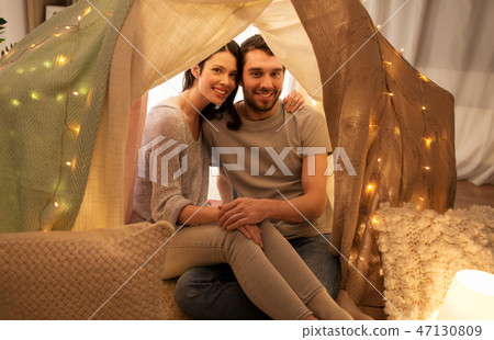 happy couple in kids tent at home happy couple in kids tent at home 47130809