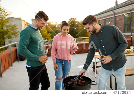 happy friends having bbq party on rooftop happy friends having bbq party on rooftop 47130924