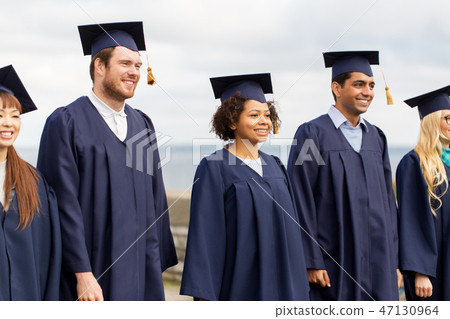 happy students or bachelors in mortar boards 47130964